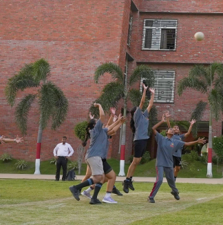 Energetic girls from MBIS participating in a competitive handball game.
